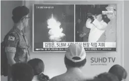  ?? ASSOCIATED PRESS ?? In this file photo, a South Korean army soldier watches a TV news program showing images published in North Korea's Rodong Sinmun newspaper of North Korea's ballistic missile believed to have been launched from underwater and North Korean leader Kim...