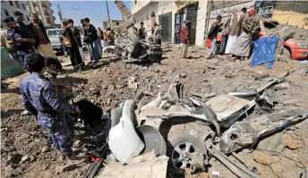  ?? — AFP photo ?? Yemenis inspect the site of reported Saudi-led airstrikes targeting the Huthi-controlled capital Sanaa.