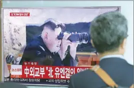  ?? AP PHOTO ?? A man walks by a TV screen showing a local news program reporting about North Korea’s missile firing with an image of North Korean leader Kim Jong Un, at Seoul Train Station in Seoul, South Korea.