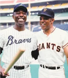  ?? Herb Scharfman / Sports Imagery / Getty Images 1970 ?? Hank Aaron (left) and Willie Mays — perhaps the two greatest players ever — share a laugh before the 1970 AllStar Game.