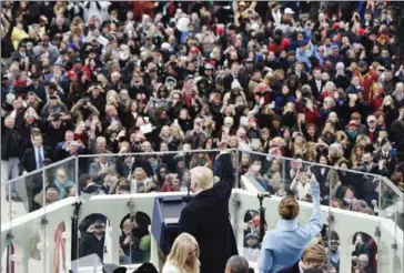  ?? BILL O’LEARY/THE WASHINGTON POST ?? US President Donald Trump and first lady Melania Trump wave to the crowd at his inaugurati­on on Friday.