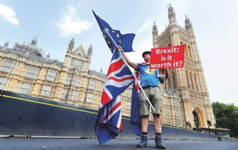  ?? Reuters ?? A man holds an anti-Brexit banner on Westminste­r Bridge, in central London, Britain. With little more than seven months to go until it leaves the EU on March 29, Britain has yet to reach an agreement with the bloc on the terms of its departure.