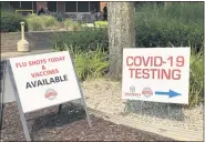  ?? STEPHEN FRYE— MEDIANEWS GROUP ?? Signs direct the public toward COVID-19testing, flu vaccines.