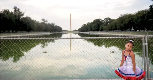  ??  ?? A young visitor to the National Mall in Washington, D.C., stands in front of temporary fencing put up for Trump’s ‘Salute to America’ on July 4