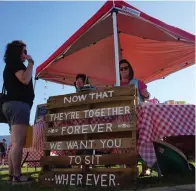  ??  ?? ■ ABOVE: The family of GBC Crafts in Atlanta has made this unusual sign to be used at weddings which normally would have a bride’s and a groom’s side for seating. “Now that they’re together forever we want you to sit wherever,” the sign says.