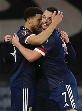  ??  ?? Che Adams, left, has adjusted to the demands of internatio­nal football as he got on the score sheet along with John McGinn