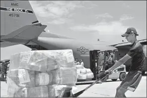  ?? U.S. Air Force/STAFF SGT. JAEL LABORN ?? Cargo provided by the U.S. Agency for Internatio­nal Developmen­t is unloaded from an Air Force plane by Peruvian workers in Lima, Peru, earlier this month. Two C-130 aircraft from Little Rock Air Force Base are transporti­ng supplies and personnel to...