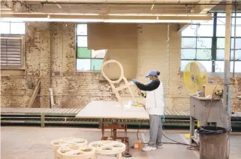  ?? THE NEW YORK TIMES ?? Unfinished chairs are sanded at Century Furniture’s Case Goods factory in Hickory, North Carolina, on Oct. 28. The furniture capital of North Carolina is ground zero for inflation, labor shortages, hot demand and limited supply. It’s debating how to cope.