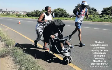  ?? / SANDILE NDLOVU ?? Modiehi Lephuthing runs 21km while pushing her son Lehlohonol­o during the Township Marathon in Eldorado Park.