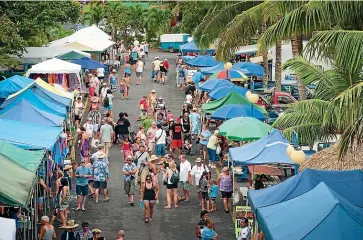  ??  ?? Visitors can shop for food on Rarotonga – or swim, stroll and simply soak up the sunshine for free.