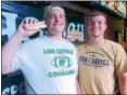  ?? JOHN KAMPF — THE NEWS‑HERALD ?? Lake Catholic’s Ryan Nocero and Brian Robinson won The News‑ Herald/Varsity Chalk Talk hot dog eating contest on Juy 25 at Hooley House in Mentor.