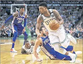  ?? CHARLES KRUPA — THE ASSOCIATED PRESS ?? The 76ers’ Marco Belinelli hits the floor as the Celtics’ Marcus Smart drives past during Wednesday night’s Game 5. The Celtics went on to win the game and the playoff series.