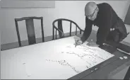  ?? PHOTOS PROVIDED TO CHINA DAILY ?? Artist Michel Comte works on his monochrome painting Salt and