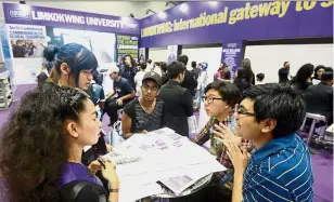  ??  ?? Visitors crowding around the Limkokwing University of Creative Technology booth ask about the courses offered.