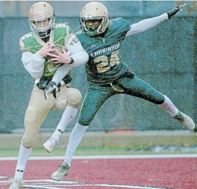  ?? CATHIE COWARD TORSTAR ?? Notre Dame’s Bryce Livingston, left, is defended by Chaminade’s Robert Gidisu as he scores his team’s touchdown in the Metro Bowl on Wednesday at Ron Joyce Stadium in Hamilton. Chaminade, from Toronto, prevailed 47-6.