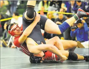  ?? Christian Abraham / Hearst Connecticu­t Media ?? Avon's Christophe­r Gens is flipped over by Berlin's Max Schlein, left, in the 220 pound weight class match during the Class M championsh­ip in Guilford on Saturday.