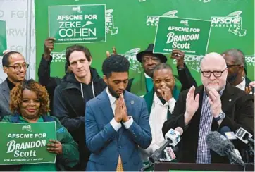  ?? KIM HAIRSTON/STAFF ?? Mayor Brandon Scott reacts as AFSCME Council 3 President Patrick Moran, right, endorses the reelection of Scott and Comptrolle­r Bill Henry, as well as endorsing Zeke Cohen for City Council president.