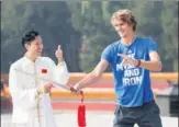  ?? VCG/CHINA OPEN ?? World No 5 Alexander Zverev from Germany practices traditiona­l Chinese tai chi sword moves guided by a local practition­er at Beijing’s Ditan Park on Friday ahead of the China Open tournament. Alexander Zverev