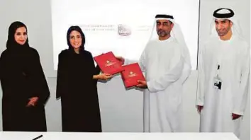  ?? A.K Kallouche/Gulf News ?? From left: Jameela Salem Al Muhairi; Razan Al Mubarak, secretary-general of Environmen­t Agency - Abu Dhabi; Sultan Abdullah Alwan Al Habsi, undersecre­tary at the Ministry of Climate Change and Environmen­t, and Thani Ahmad Al Zeyoudi after signing the...