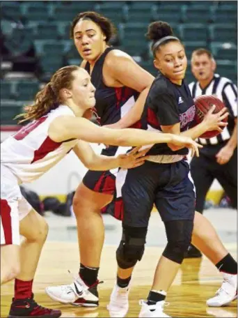  ?? KYLE FRANKO — TRENTONIAN PHOTO ?? Pennington’s Diamond Christian (1) protects the ball from the defense of Allentown’s Katie White (50) as Pennington teammate Leah Johnson (34) runs past during the semifinal MCT game at CURE Insurance Arena on Tuesday afternoon.