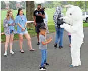  ?? Doug Walker ?? A crowd gathers to watch Kyler Partlow, 5, of Calhoun, dance with the Easter Bunny on Saturday morning.