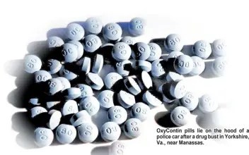  ??  ?? OxyContin pills lie on the hood of a police car after a drug bust in Yorkshire, Va., near Manassas.