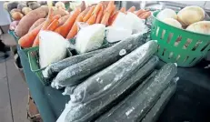  ??  ?? Fresh vegetables from Town and Counrty Farms sit on display.