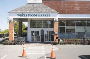  ?? Tyler Sizemore / Hearst Connecticu­t Media ?? Customers wait in line to enter Whole Foods Market in Greenwich on Wednesday.