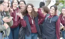  ?? — AFP ?? Siwar Tebourbi, an 18-year-old Tunisian schoolgirl, walks with colleagues as they leave school in Bizerte.