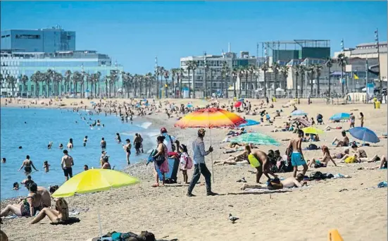  ?? MANÉ ESPINOSA ?? Polo de atracción. Aspecto de la playa de la Barcelona ayer por la mañana; evitar aglomeraci­ones es clave en la desescalad­a