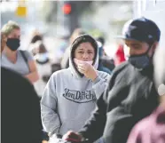  ?? ROBYN BECK / AFP VIA GETTY IMAGES ?? People wait in line for a Thanksgivi­ng meal take-home
food kit at a mission in Los Angeles on Friday.