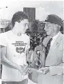  ??  ?? 1986: Arnold Foote Jr, first place in the men’s category in the Pepsi Cross-the-Harbour Swim in September, receives the winner’s trophy from Paul Geddes (right), chairman of Desnoes and Geddes Limited. Foote finished second in the race behind Rachel...