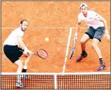  ??  ?? Germany’s Jan-Lennard Struff (right), and Tim Puetz return the ball during the Davis Cup quarter-final doubles tennis match against Spain’s Marc Lopez and Feliciano Lopez at the bullring of Valencia, on April 7.
(AFP)