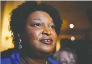  ?? AP FILE PHOTO/BRYNN ANDERSON ?? Georgia gubernator­ial Democratic candidate Stacey Abrams talks to the media after qualifying for the 2022 election on March 8 in Atlanta.