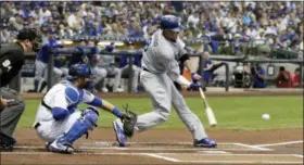  ?? MORRY GASH — THE ASSOCIATED PRESS ?? Los Angeles Dodgers’ Manny Machado hits a single during the first inning of a baseball game against the Milwaukee Brewers Friday in Milwaukee.