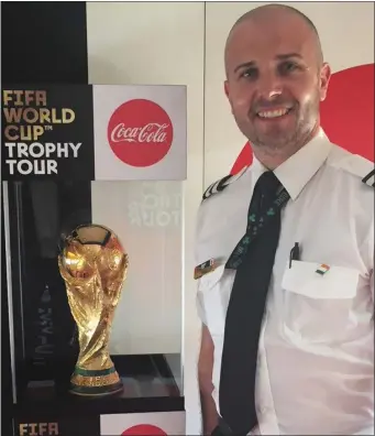  ??  ?? First Officer Brian McGovern with the World Cup trophy that he transporte­d around Africa.