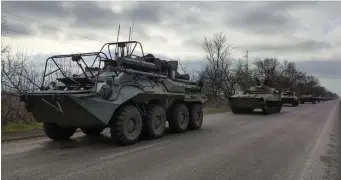  ?? Ap ?? ON THE MOVE: A Russian military convoy travels on a highway near Mariupol, Ukraine, on Saturday.