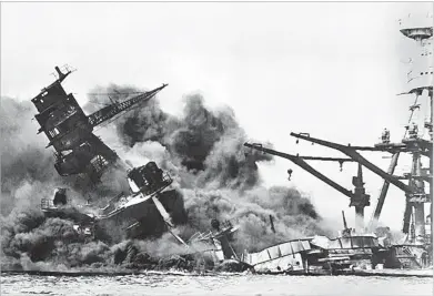  ?? ASSOCIATED PRESS FILE PHOTO ?? The battleship USS Arizona belches smoke as it topples over into the sea Dec. 7, 1941, during Japan’s surprise attack on Pearl Harbor, Hawaii. The ship sank with more than 80 percent of its 1,500-man crew, including Oren Sumner.