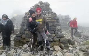  ??  ?? ●● John and Janet Thorley at the summit of Ben Nevis after climbing the peak for Marie Curie