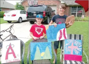  ?? MARK HUMPHREY ENTERPRISE-LEADER ?? Tristan Hall, 10 (left) and Ethan Mallard, 15, of Farmington, display paintings, made by Tristan, the boys are selling as a fundraiser on behalf of his “Meme,” grandmothe­r Deb Majors, who is battling cancer. The boys are operating a lemonade stand on...