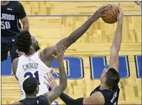  ?? PHELAN M. EBENHACK — THE ASSOCIATED PRESS ?? Philadelph­ia 76ers center Joel Embiid (21) and Orlando Magic center Nikola Vucevic, right, go for a ball during the first half of an NBA basketball game Thursday, Dec. 31, 2020, in Orlando, Fla.