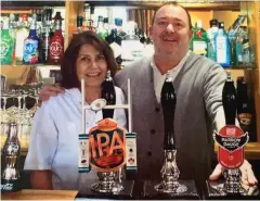  ??  ?? Cheers: Linda and Pete Layton behind the bar at The Fox