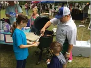  ?? NEWS-HERALD FILE ?? Lily Holt, left, and her father, Ben, prepare to serve a hot dog at the 2018Septem­berfest. This annual celebratio­n is one of the community events sponsored by the Madison Joint Recreation District. The district seeks passage of a 0.64-mill additional parks and recreation levy on the March 17ballot.