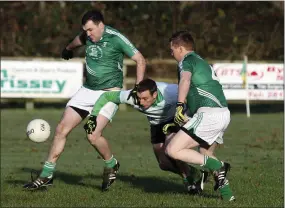  ??  ?? Avondale’s Shane O’Neill hacks the ball clear of Hollywood’s Brian Flynn during the 1916 Cup semi-final in Laragh. Photo: Garry O’Neill