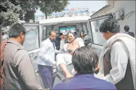  ?? Rafiq Maqbool The Associated Press ?? A wounded man is carried to an ambulance after an explosion Wednesday in Kabul, Afghanista­n. A suicide car bomber targeted the police headquarte­rs in western Kabul.