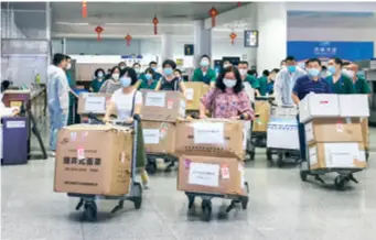  ??  ?? A medical aid team from Wuhan, Hubei Province, arrives in Urumqi, Xinjiang Uygur Autonomous Region, on July 18