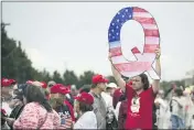  ?? MATT ROURKE — THE ASSOCIATED PRESS FILE ?? On Aug. 2, 2018, a protesters holding a Q sign waits in line with others to enter a campaign rally with President Donald Trump inWilkes-Barre, Pa.