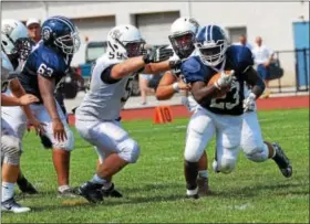  ?? SAM STEWART - DIGITAL FIRST MEDIA ?? Pottstown’s Anthony Wiggins breaks free from a host of tacklers during the second half.