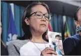  ?? JUSTIN TANG
THE CANADIAN PRESS ?? Debbie Baptiste, mother of Colten Boushie, holds a photo of her son, who was fatally shot by a farmer in 2016.