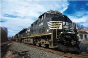  ?? AP PHOTO/GENE J. PUSKAR ?? On Feb. 9, a Norfolk Southern freight train passes passes through East Palestine, Ohio.